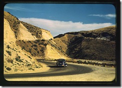 Road cut into the barren hills which lead into Emmett. Emmett, Idaho, July 1941. Reproduction from color slide. Photo by Russell Lee. Prints and Photographs Division, Library of Congress